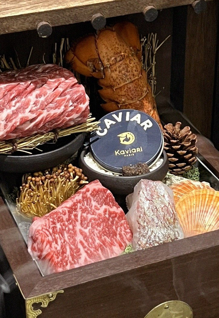 DAEBOJUNG Yeouido · the signature Hanwoo showing — marbled beef cuts and caviar presented in a display chest