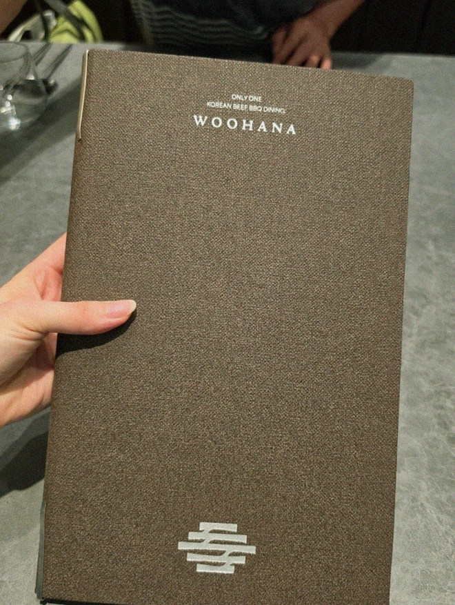 WOOHANA Yeouido · the signature Hanwoo showing — marbled beef cuts and caviar presented in a display chest