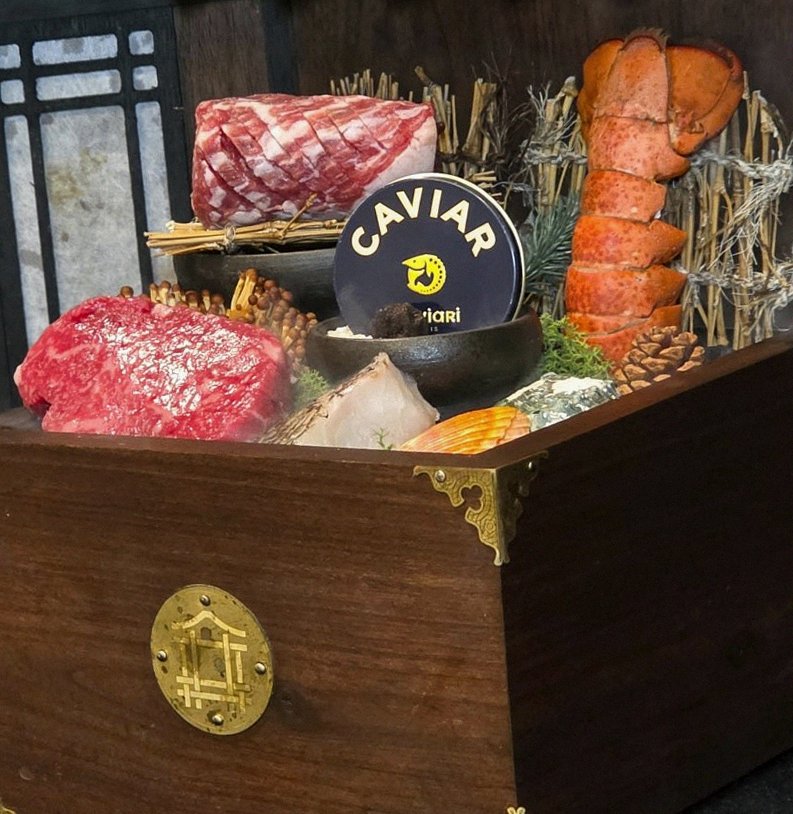 DAEBOJUNG City Hall · the signature Hanwoo showing — marbled beef cuts and caviar presented in a display chest