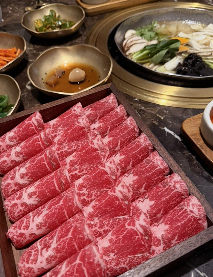 DAEBOJUNG Yeouido · the signature Hanwoo showing — marbled beef cuts and caviar presented in a display chest