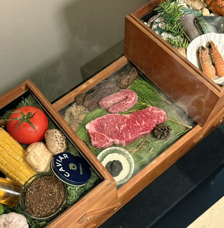 WOOARA Yeouido · the signature Hanwoo showing — marbled beef cuts and caviar presented in a display chest