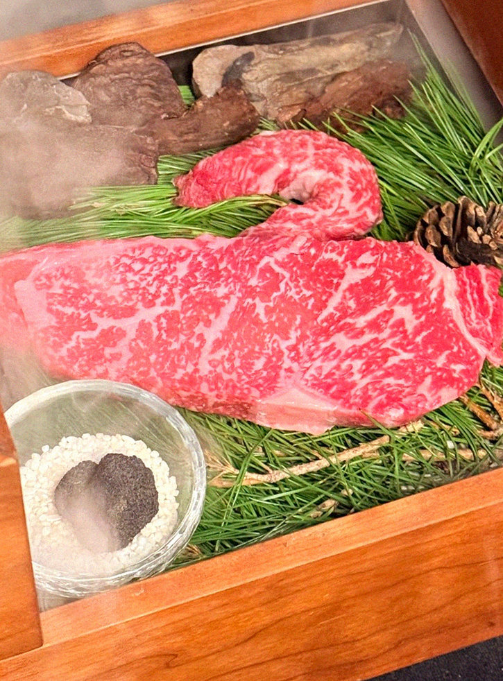 WOOARA Yeouido · the signature Hanwoo showing — marbled beef cuts and caviar presented in a display chest