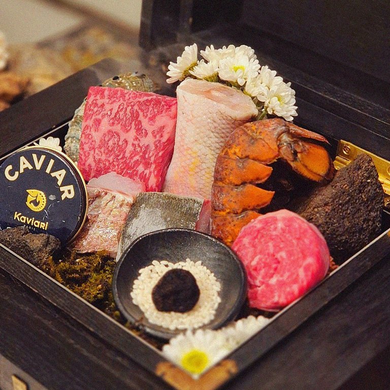 GOWOOGA Gwanghwamun · the signature Hanwoo showing — marbled beef cuts and caviar presented in a display chest